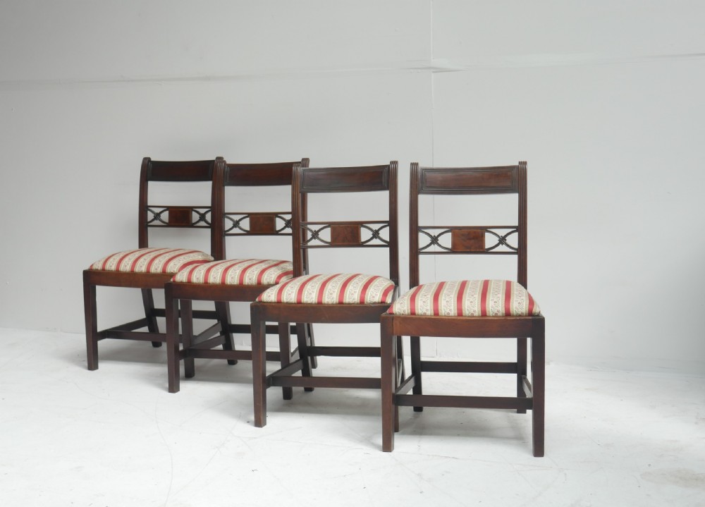Set of four dark mahogany Regency dining chairs with reeded frames and red and cream striped fabric seats. View X