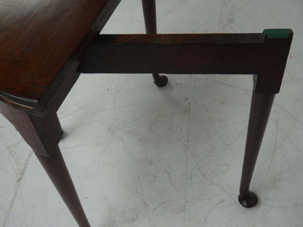 An 18th-century mahogany demi-lune games table featuring a folding semi-circular top supported by slender legs with pad feet. View II