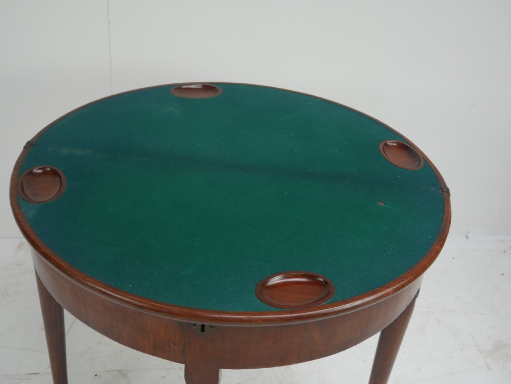 An 18th-century mahogany demi-lune games table featuring a folding semi-circular top supported by slender legs with pad feet. View III