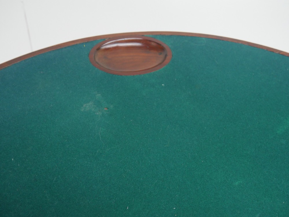 An 18th-century mahogany demi-lune games table featuring a folding semi-circular top supported by slender legs with pad feet. View VI