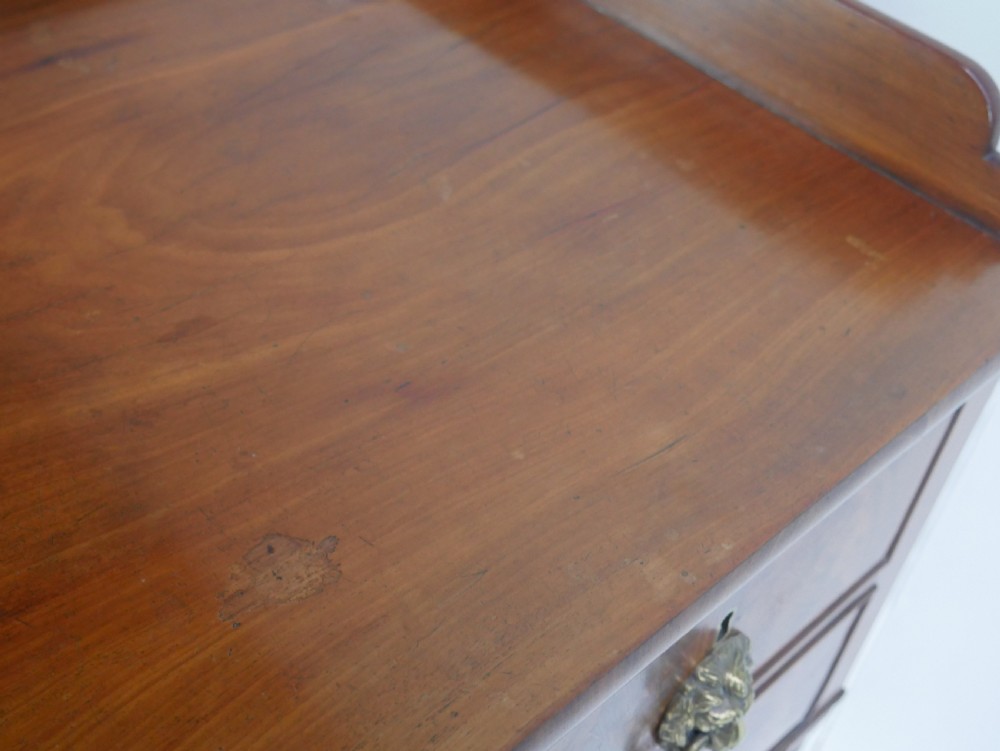 A Regency flame mahogany sideboard featuring five drawers with brass lion mask handles, turned reeded legs, and carved corner brackets. View XIII