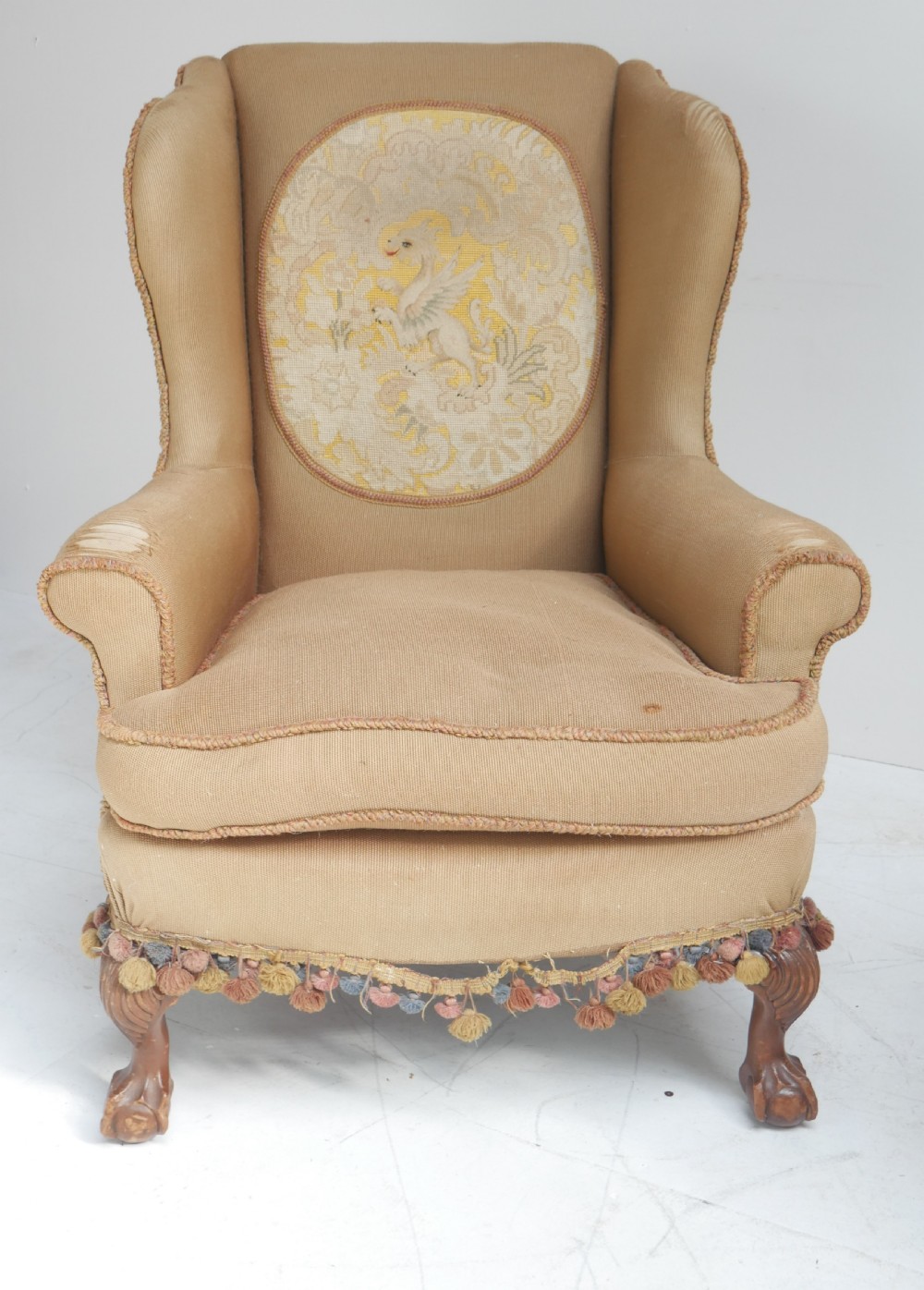 A pair of 1920s wingback armchairs upholstered in gold fabric featuring oval embroidered back panels and carved walnut ball and claw feet. View VI