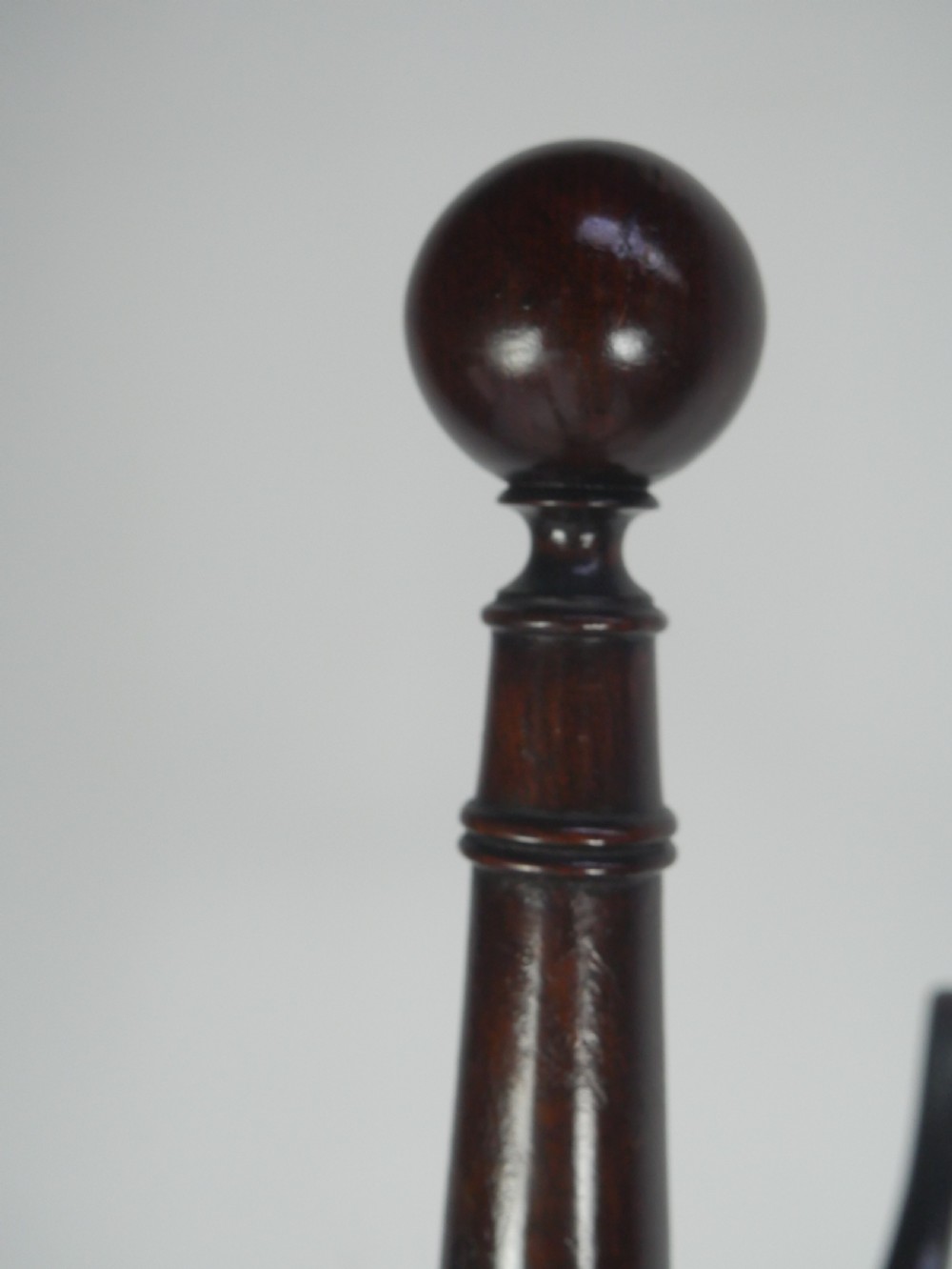 A tall 19th-century turned dark mahogany hat and coat stand with tiered curved branches and a tripod base. View V