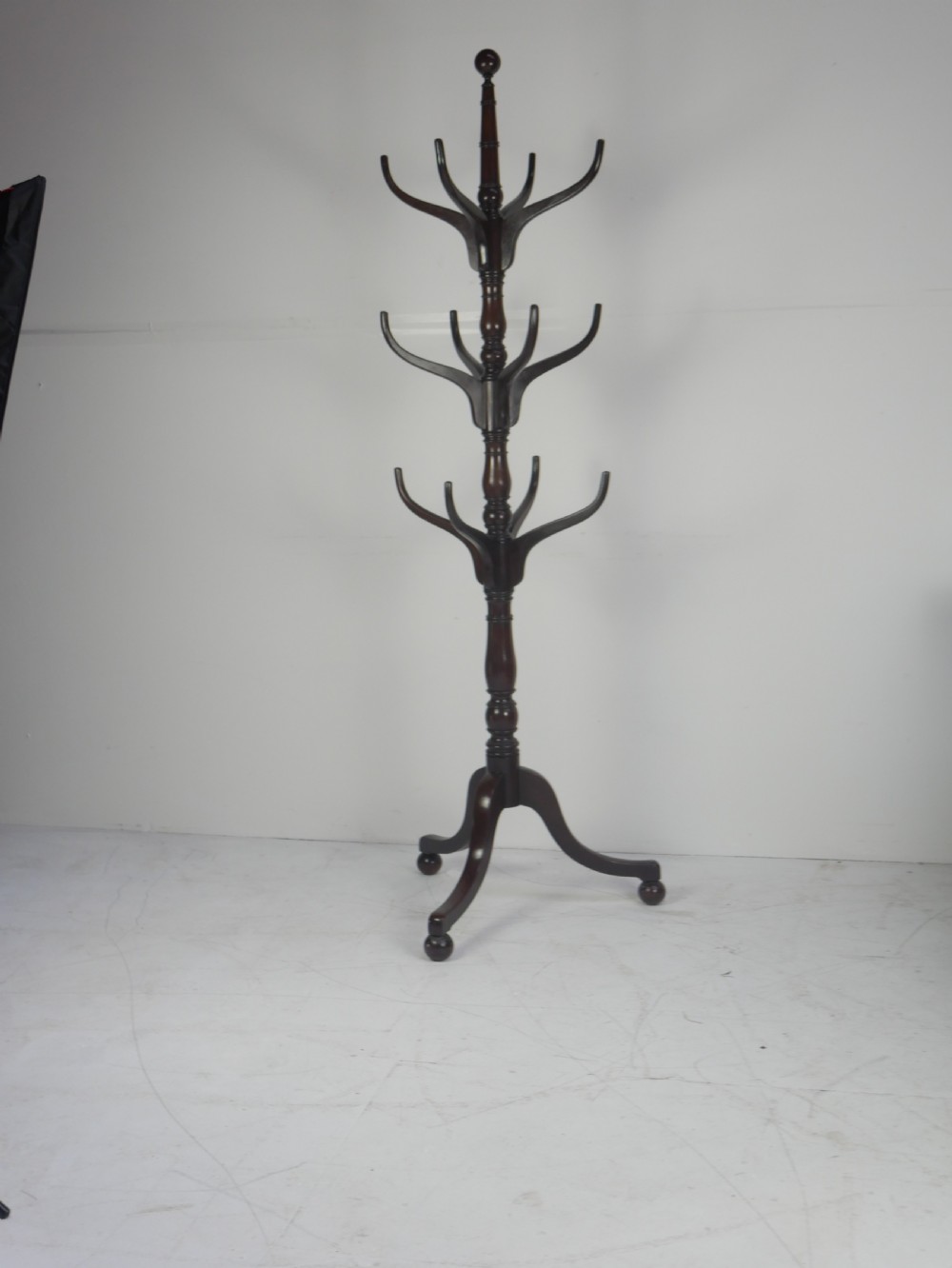 A tall 19th-century turned dark mahogany hat and coat stand with tiered curved branches and a tripod base. View VIII