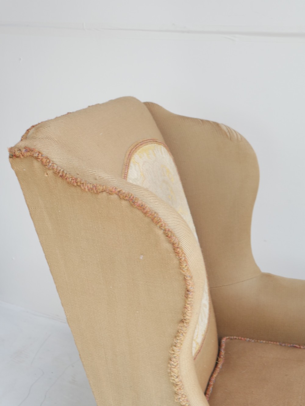 A pair of 1920s wingback armchairs upholstered in gold fabric featuring oval embroidered back panels and carved walnut ball and claw feet. View III