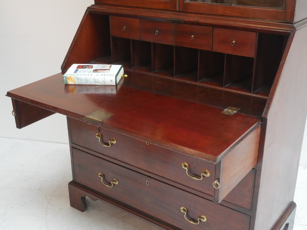 A Georgian mahogany bureau bookcase featuring a two-door glazed upper cabinet, a slant-front writing bureau, and three long drawers with brass handles. View III
