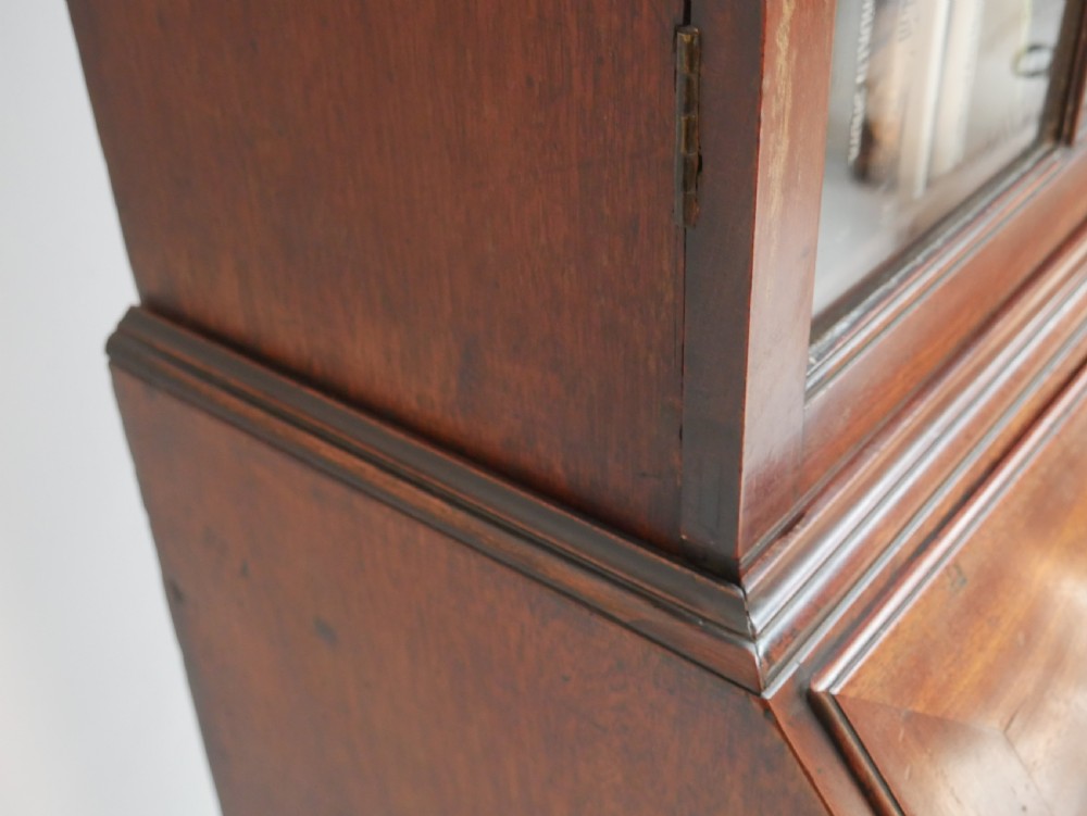 A Georgian mahogany bureau bookcase featuring a two-door glazed upper cabinet, a slant-front writing bureau, and three long drawers with brass handles. View XII