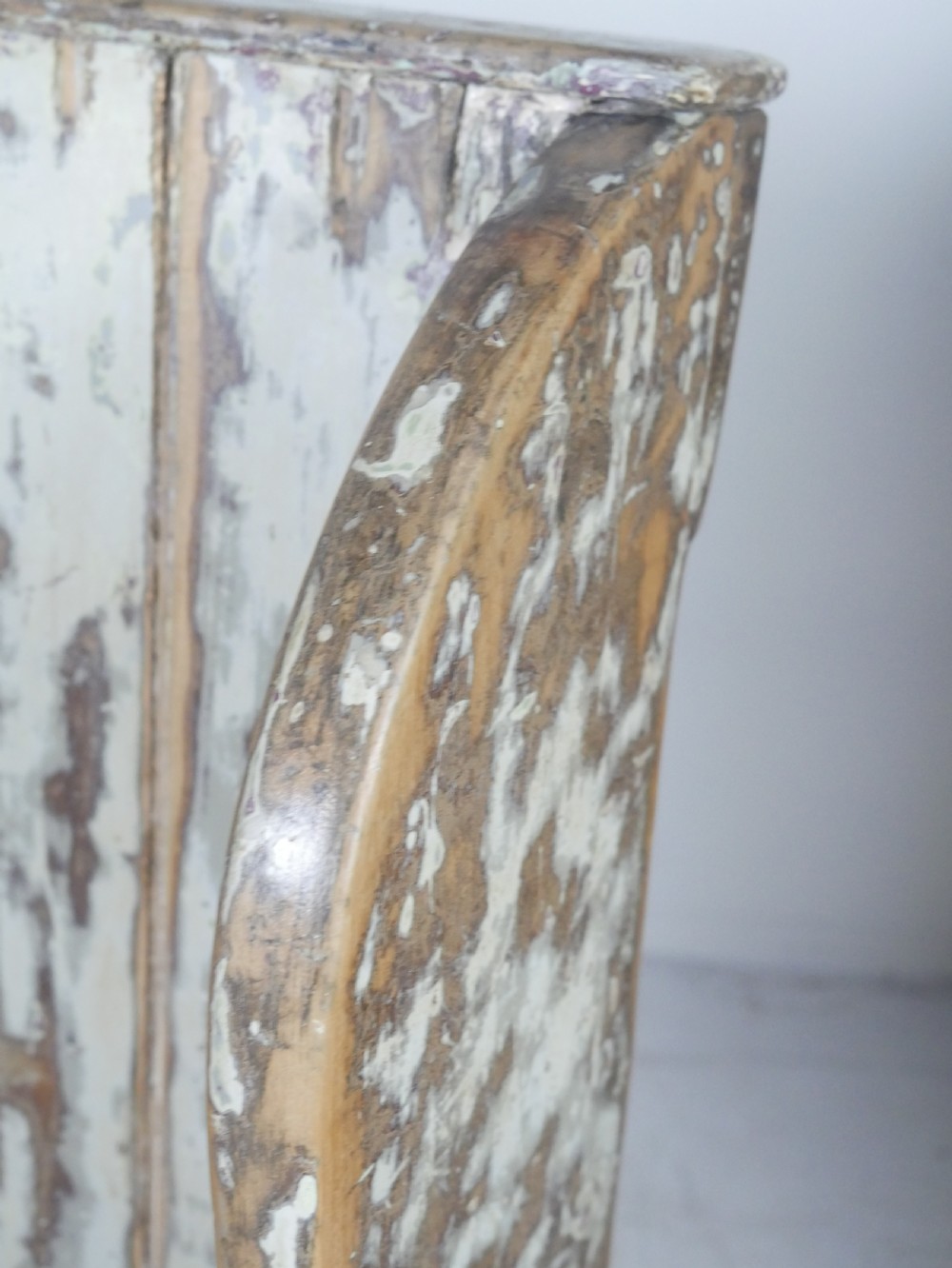 A large high-backed wooden settle bench featuring distressed cream paint over natural wood and vertical panelled detailing. View VIII