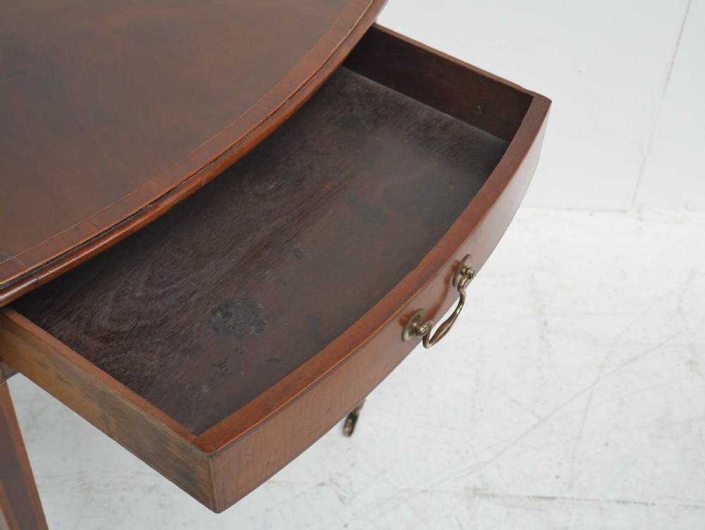 A Georgian mahogany Pembroke table featuring two drop leaves, a single drawer with a brass handle, string inlay on square tapered legs, and brass castors. View V