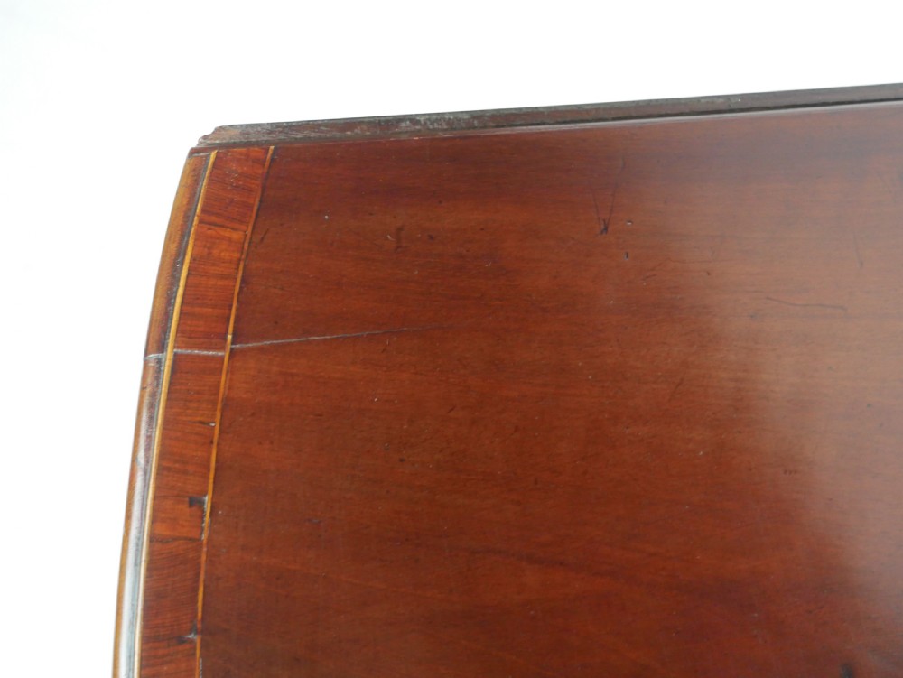 A Georgian mahogany Pembroke table featuring two drop leaves, a single drawer with a brass handle, string inlay on square tapered legs, and brass castors. View VIII