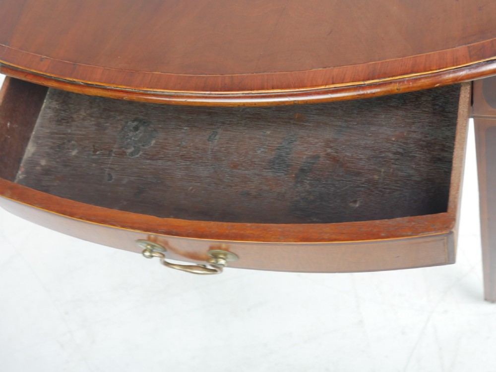 A Georgian mahogany Pembroke table featuring two drop leaves, a single drawer with a brass handle, string inlay on square tapered legs, and brass castors. View IX