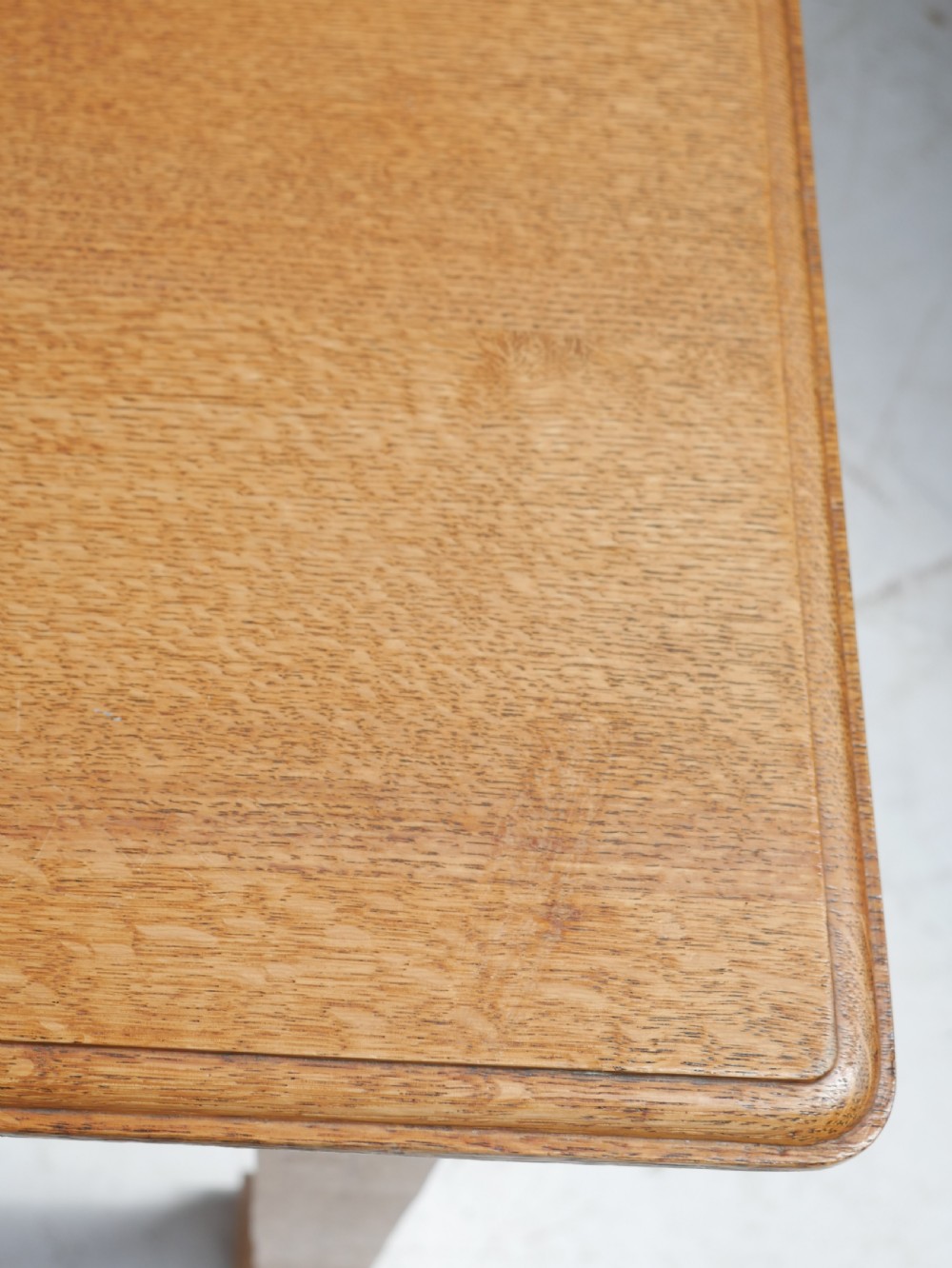 A rectangular solid oak table from the 1920s featuring tapered legs with flared feet and a moulded top edge. View IV