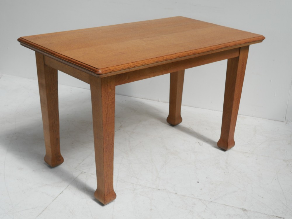 A rectangular solid oak table from the 1920s featuring tapered legs with flared feet and a moulded top edge. View VIII