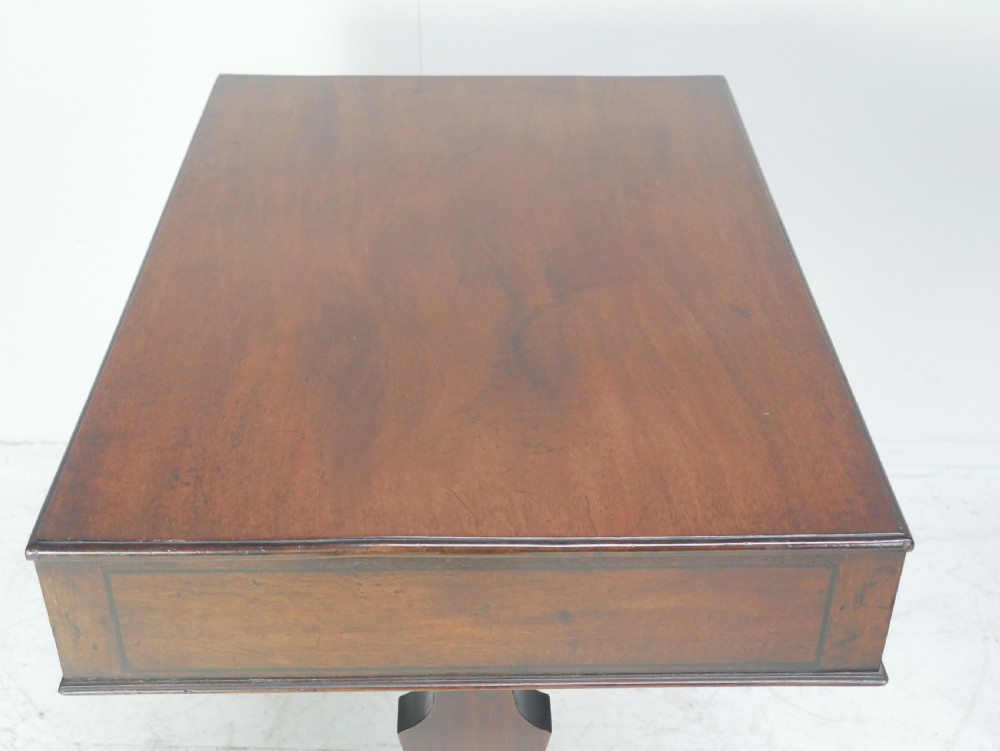 A Regency mahogany side table featuring a single drawer with brass knobs, a turned cross stretcher, and splayed legs on castors. View VI