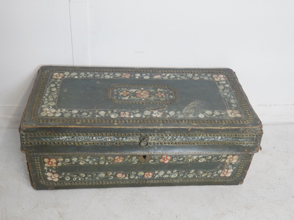 A dark green rectangular leather trunk decorated with hand-painted floral borders and studded brass tacks around the edges. View III