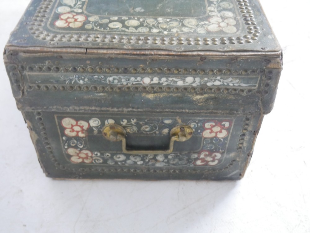 A dark green rectangular leather trunk decorated with hand-painted floral borders and studded brass tacks around the edges. View VII