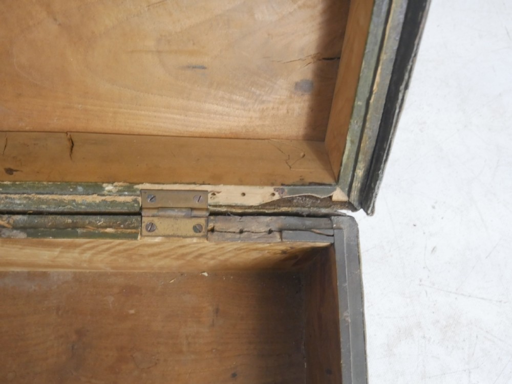 A dark green rectangular leather trunk decorated with hand-painted floral borders and studded brass tacks around the edges. View XII