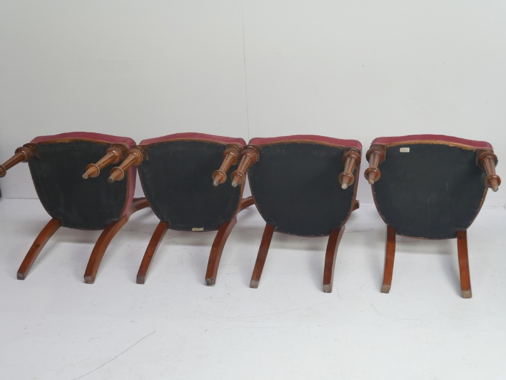 A set of four 19th-century Victorian walnut balloon-back chairs upholstered in rose pink velvet with carved back rails and turned front legs. View VI