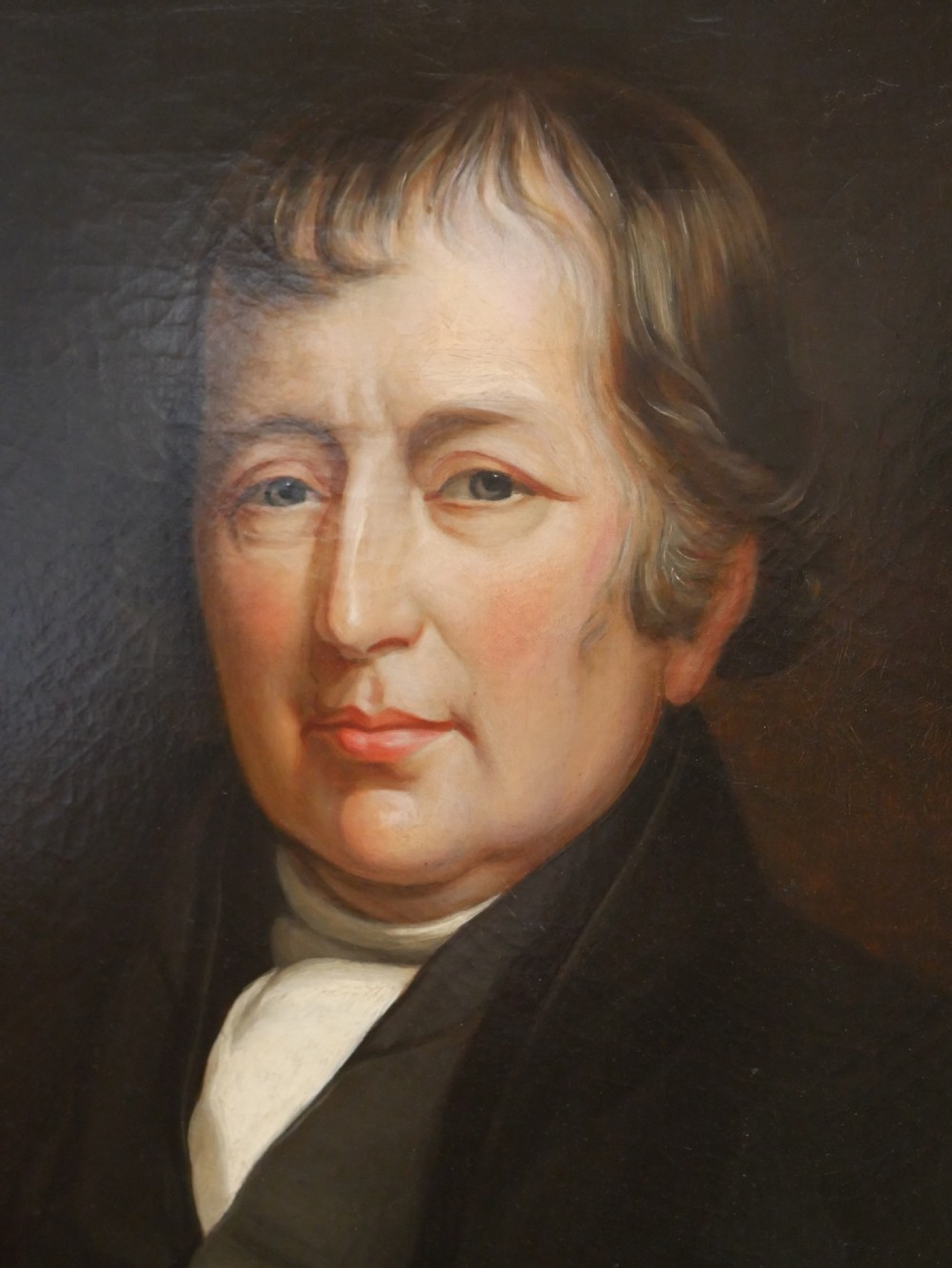 A 19th-century oil painting depicting a gentleman in formal dark attire, framed within an elaborate gold gilt frame. View II