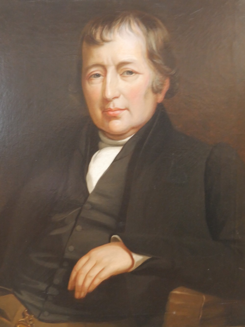 A 19th-century oil painting depicting a gentleman in formal dark attire, framed within an elaborate gold gilt frame. View XIV