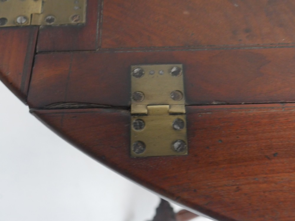 A Regency mahogany butlers tray featuring cutout handles and hinged sides resting on a turned folding X-frame stand. View VI