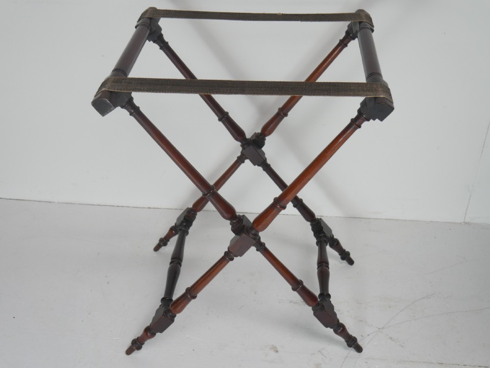 A Regency mahogany butlers tray featuring cutout handles and hinged sides resting on a turned folding X-frame stand. View VII