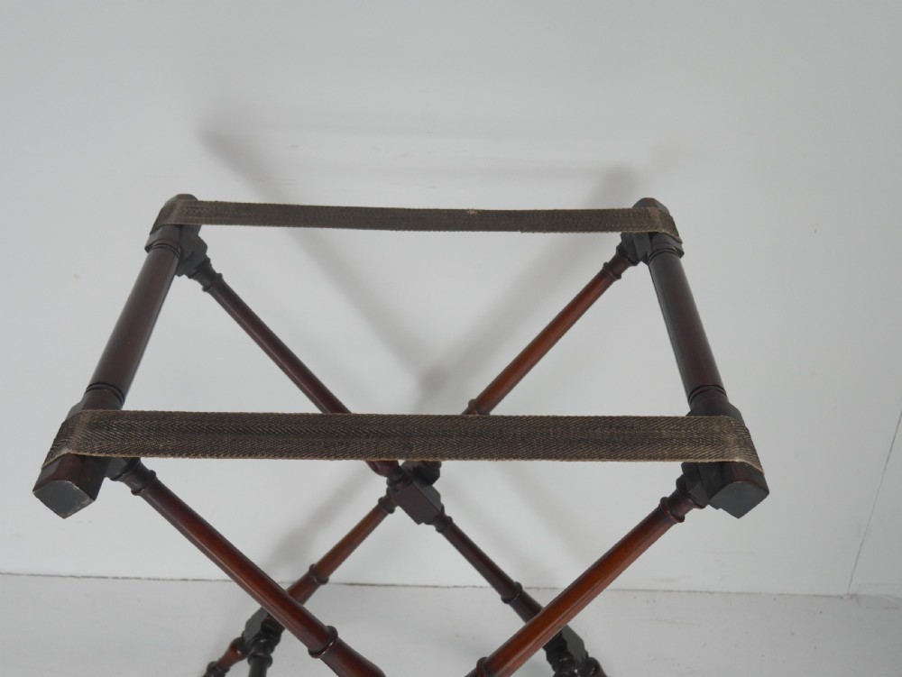 A Regency mahogany butlers tray featuring cutout handles and hinged sides resting on a turned folding X-frame stand. View VIII