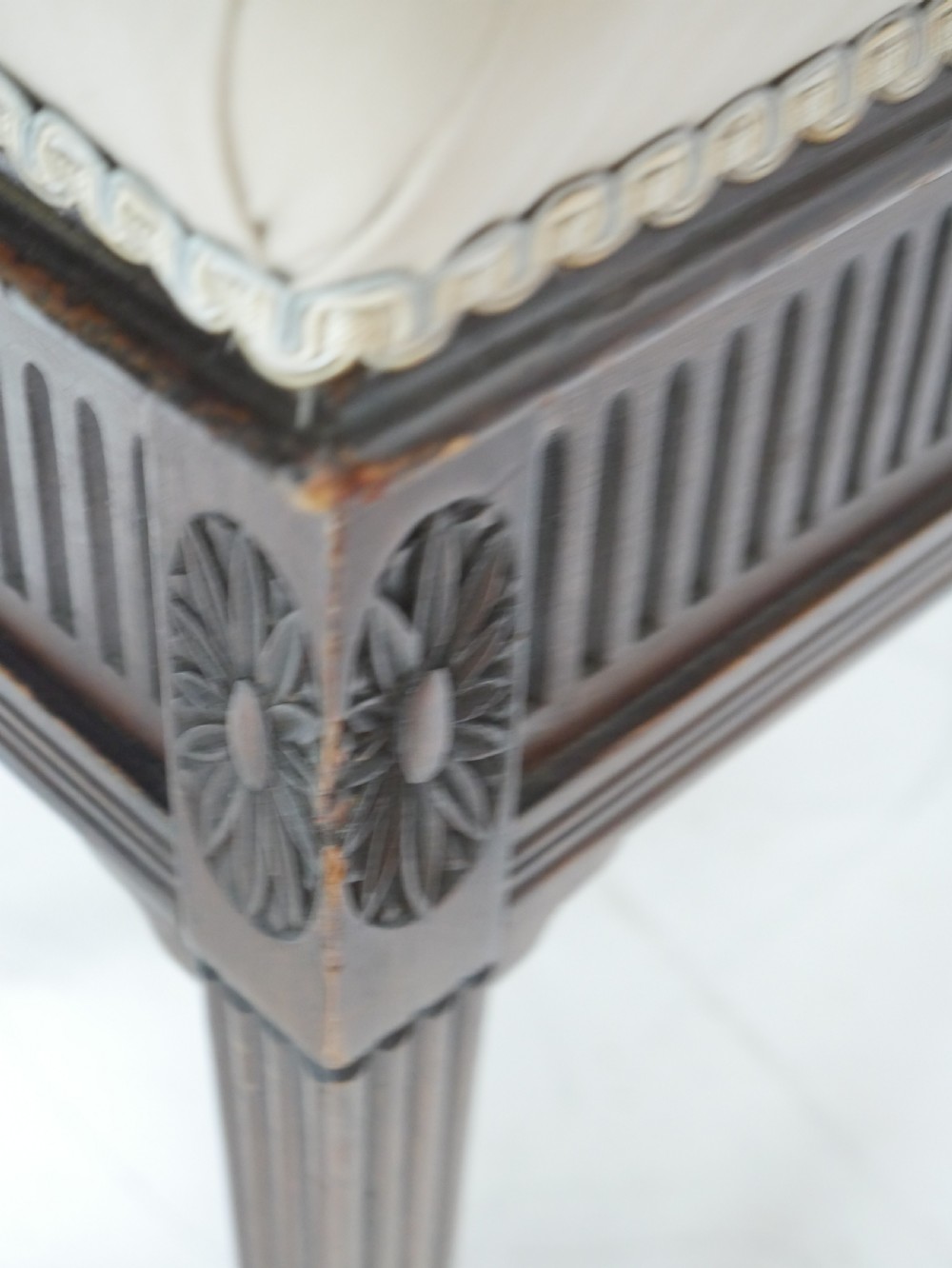 A rectangular antique mahogany piano stool featuring fluted tapered legs, carved central rosettes, and a floral needlepoint tapestry top. View IX