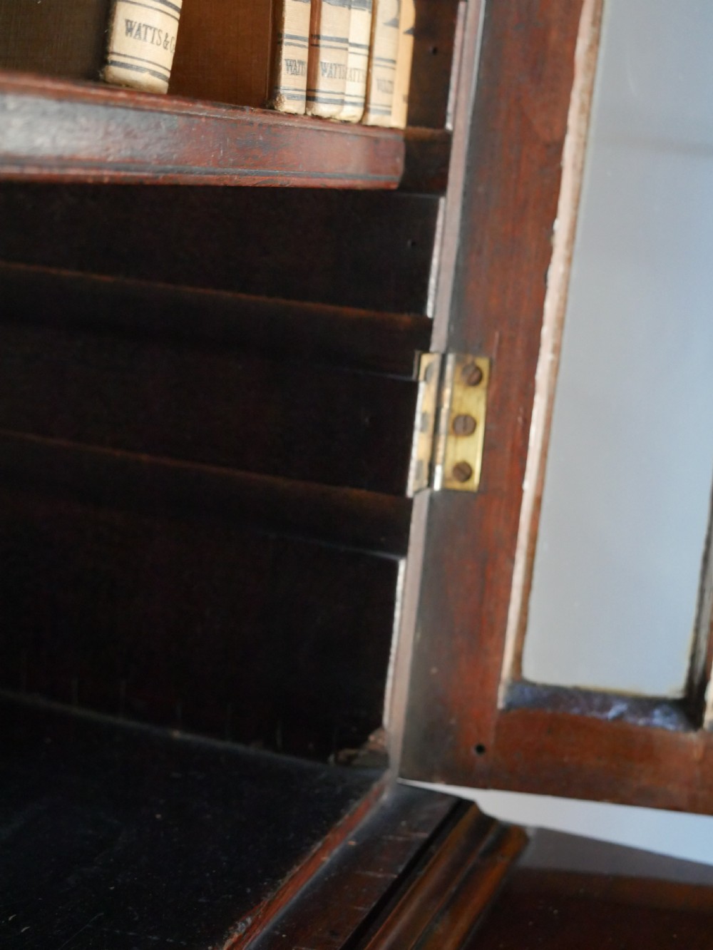 A 19th-century dark mahogany secretaire bookcase featuring an upper glazed two-door cabinet over a drop-front fitted writing desk and three lower drawers. View X