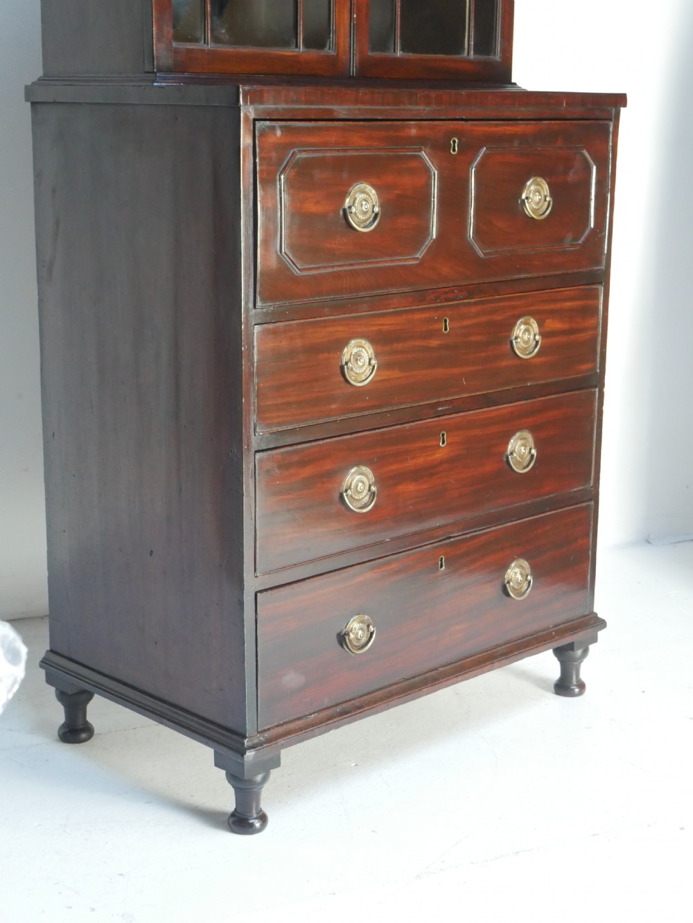 A 19th-century dark mahogany secretaire bookcase featuring an upper glazed two-door cabinet over a drop-front fitted writing desk and three lower drawers. View II