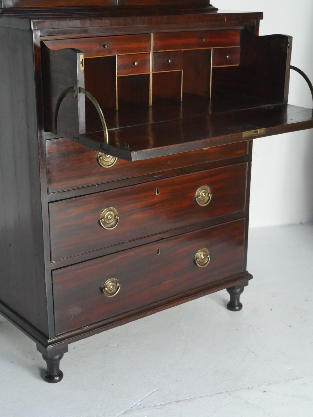 A 19th-century dark mahogany secretaire bookcase featuring an upper glazed two-door cabinet over a drop-front fitted writing desk and three lower drawers. View XI
