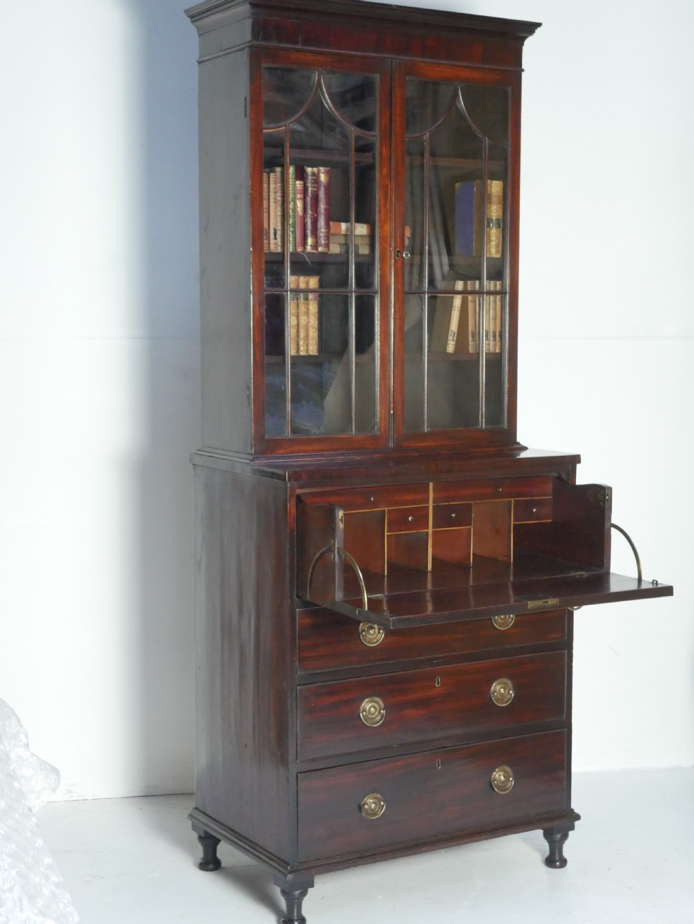 A 19th-century dark mahogany secretaire bookcase featuring an upper glazed two-door cabinet over a drop-front fitted writing desk and three lower drawers. View XII