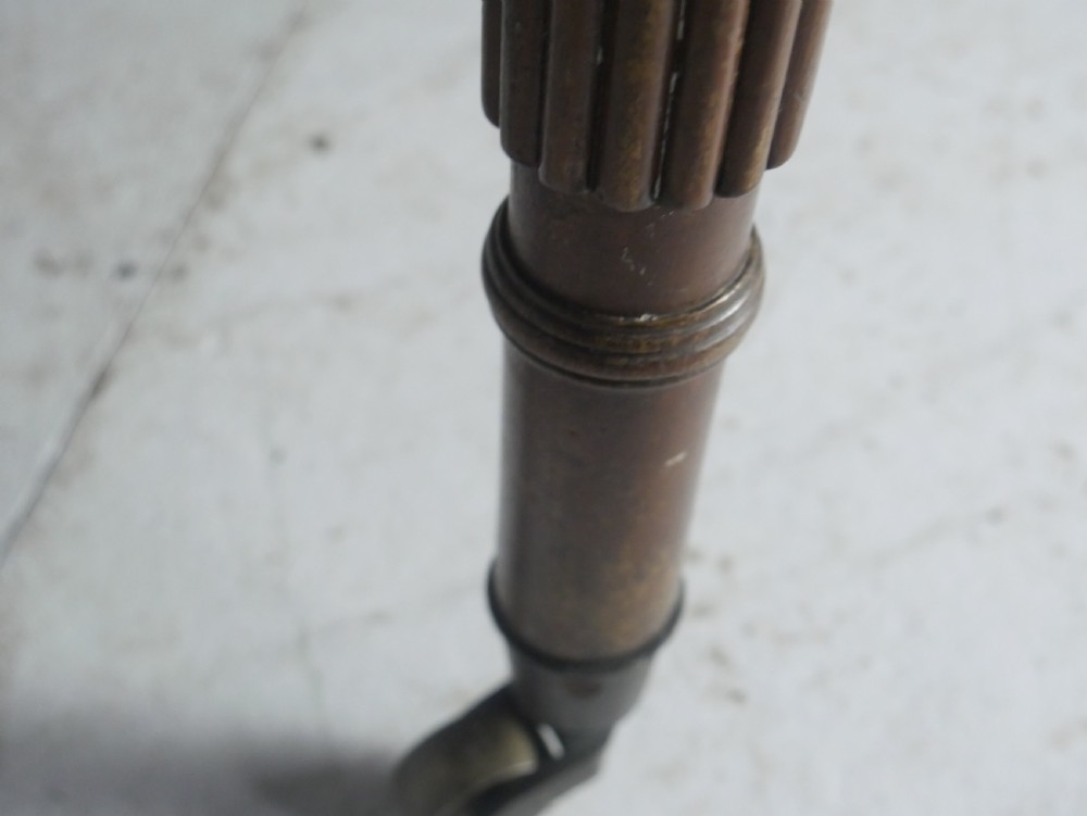 An antique mahogany drop-leaf dining table with reeded legs set on brass castors, shown fully extended. View VI