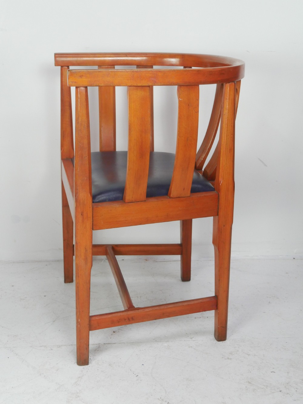 A pair of warm wood Arts and Crafts tub chairs with curved slat backs and blue upholstered seats. View III