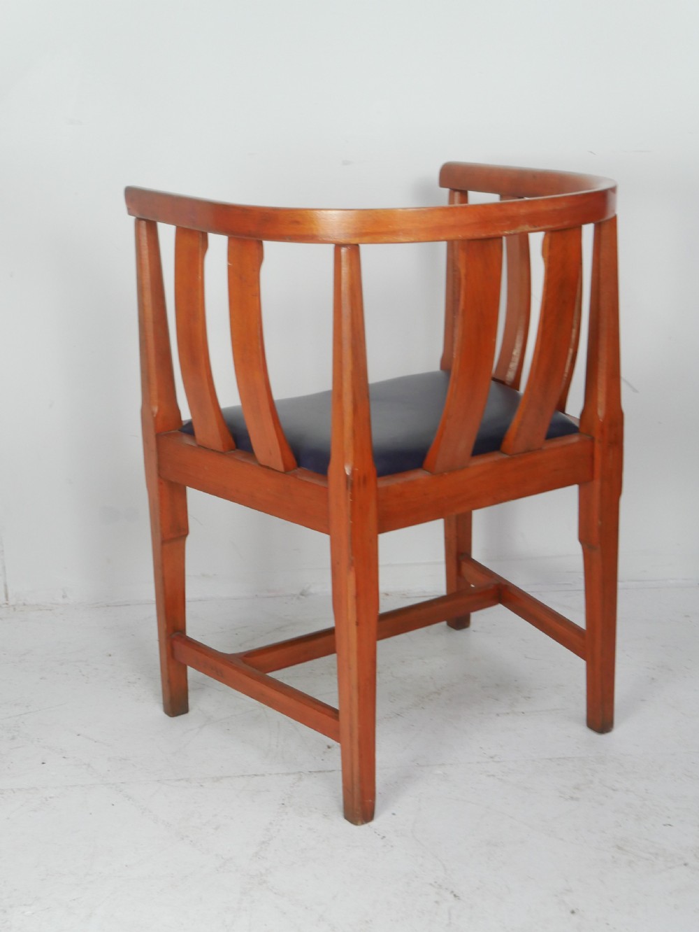 A pair of warm wood Arts and Crafts tub chairs with curved slat backs and blue upholstered seats. View IV
