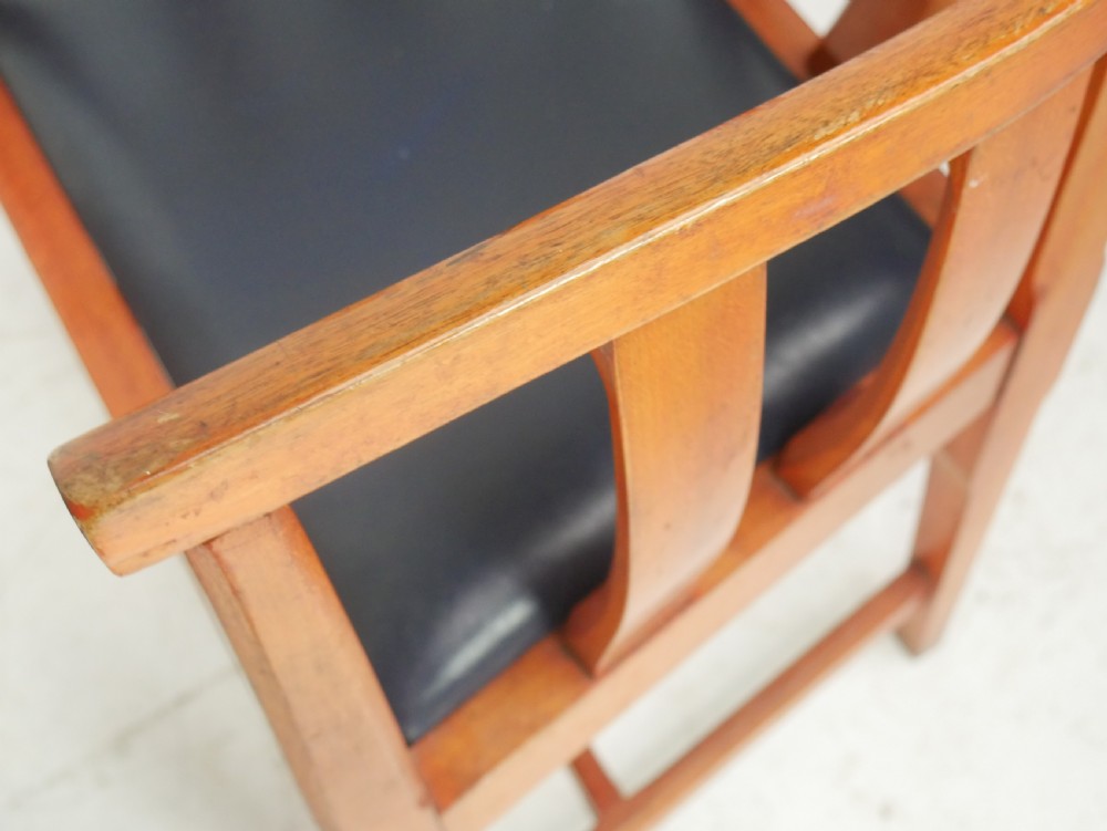 A pair of warm wood Arts and Crafts tub chairs with curved slat backs and blue upholstered seats. View X