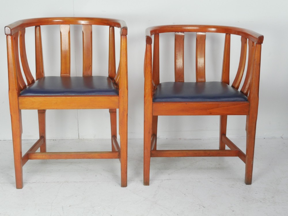 A pair of warm wood Arts and Crafts tub chairs with curved slat backs and blue upholstered seats. View XII
