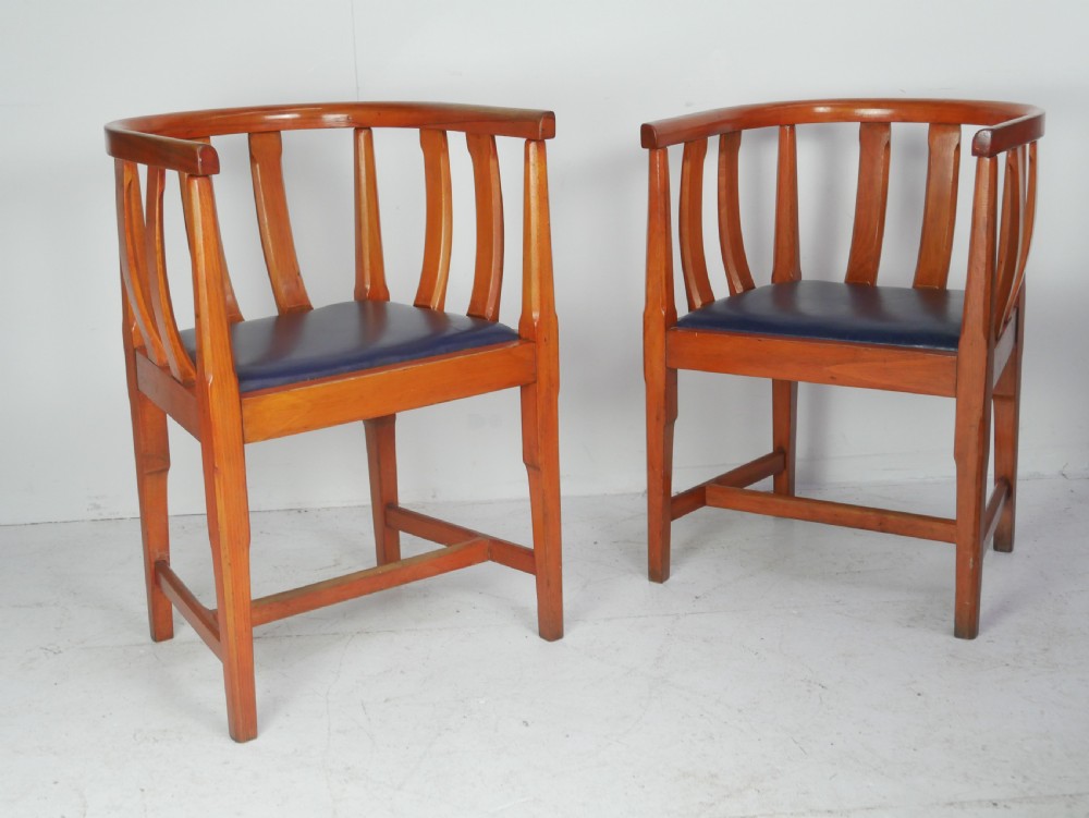 A pair of warm wood Arts and Crafts tub chairs with curved slat backs and blue upholstered seats. View XIV