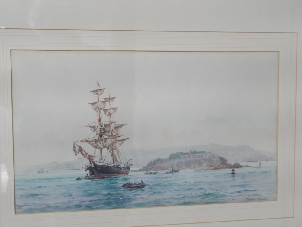 A framed Edwardian marine watercolour painting depicting a multi-masted sailing vessel at anchor near a hilly coastline in a slender gilt frame with a double mount. View II