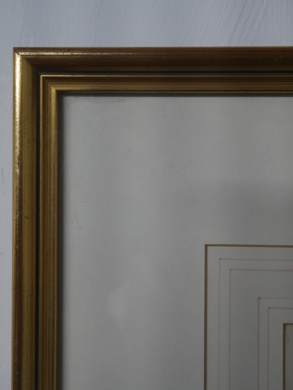 A framed Edwardian marine watercolour painting depicting a multi-masted sailing vessel at anchor near a hilly coastline in a slender gilt frame with a double mount. View V