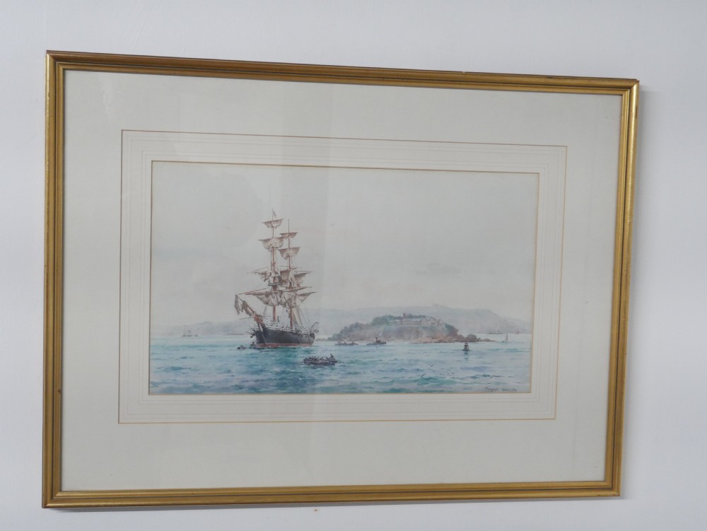 A framed Edwardian marine watercolour painting depicting a multi-masted sailing vessel at anchor near a hilly coastline in a slender gilt frame with a double mount. View VIII