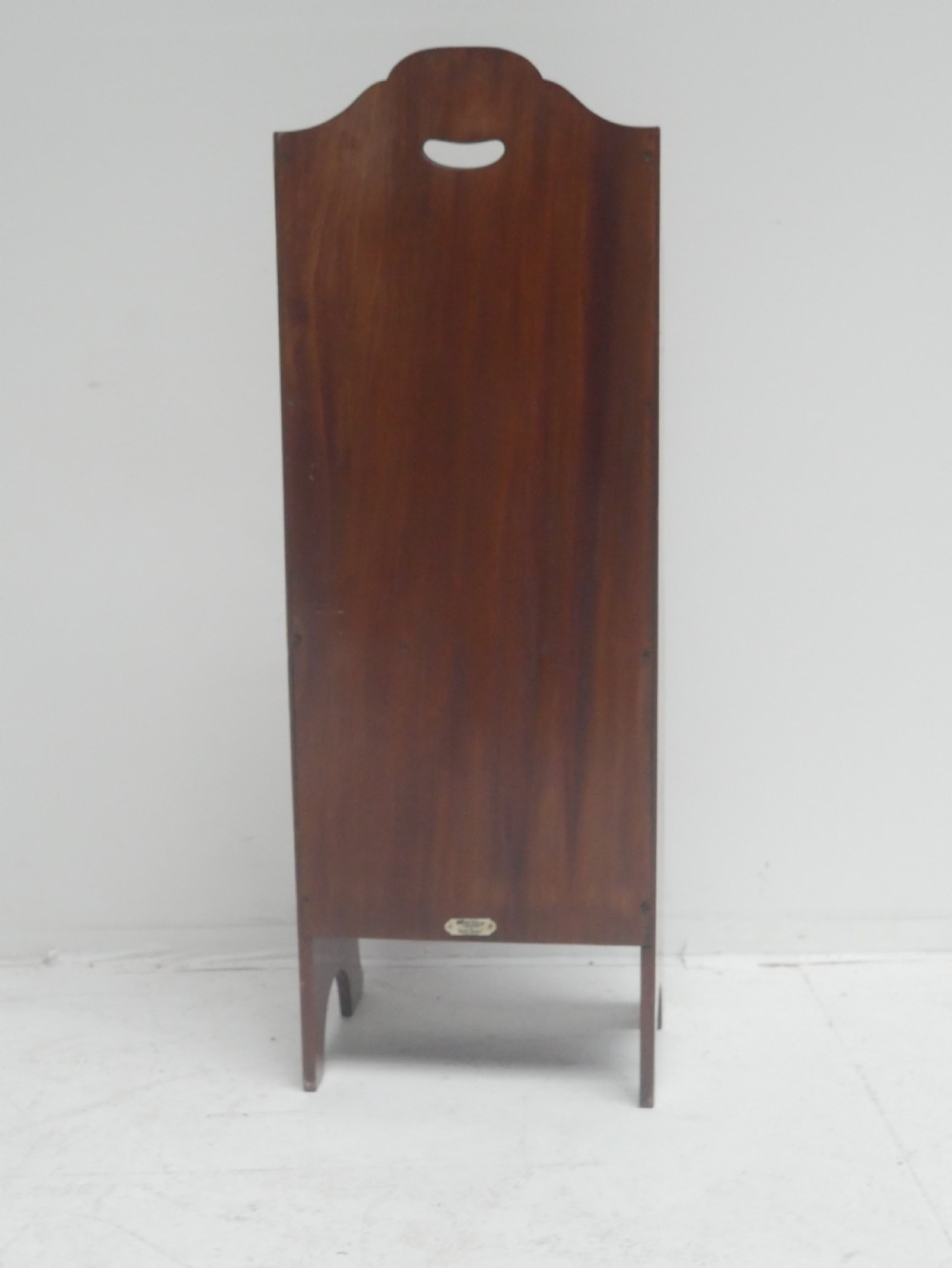 A freestanding three-tiered mahogany magazine rack featuring curved cutout fronts, an integrated top handle, and inlaid stringing borders on splayed feet. View X