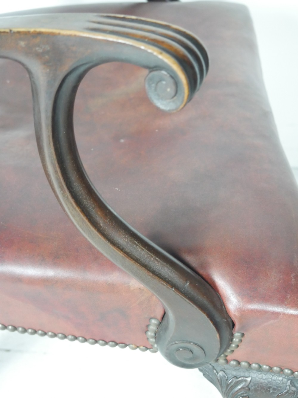 A pair of 19th-century Chippendale style mahogany armchairs featuring pierced back splats, reddish-brown leather seats with studding, and cabriole legs with ball-and-claw feet. View III