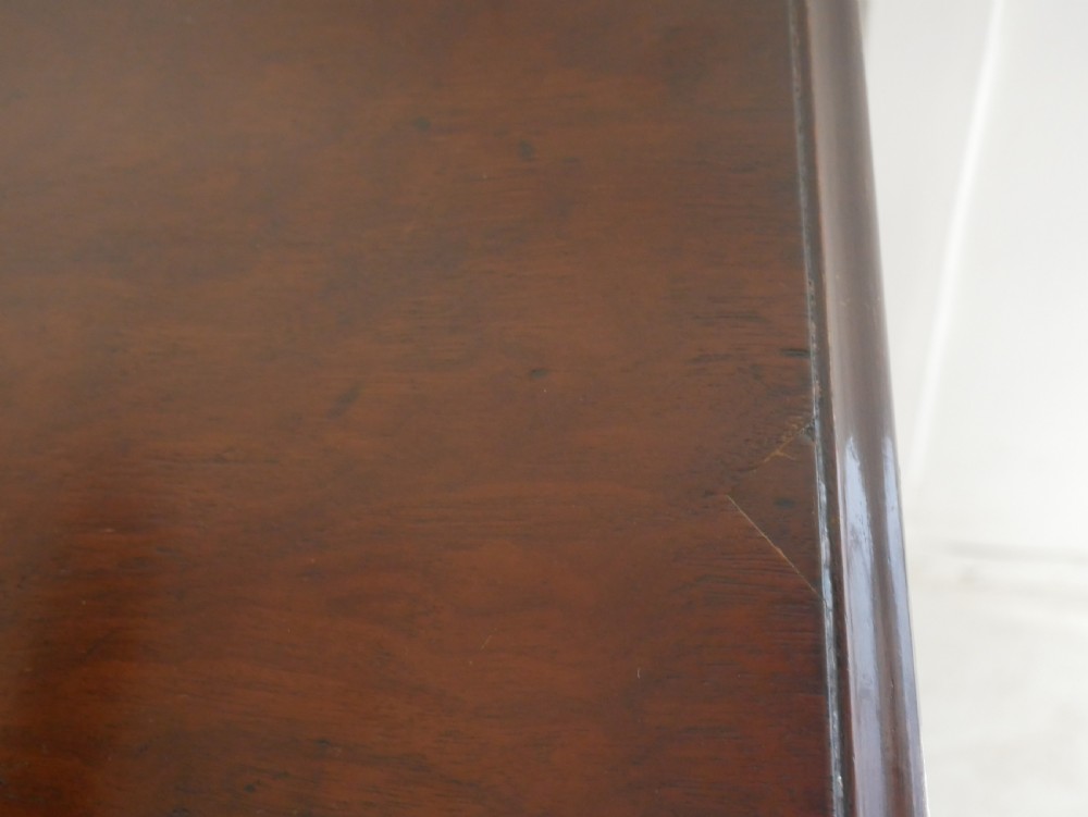 A Georgian mahogany chest of drawers featuring a two-over-three drawer layout, brass swan-neck handles, and bracket feet. View V