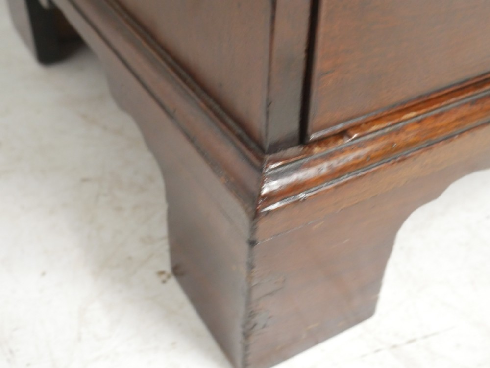A Georgian mahogany chest of drawers featuring a two-over-three drawer layout, brass swan-neck handles, and bracket feet. View IX