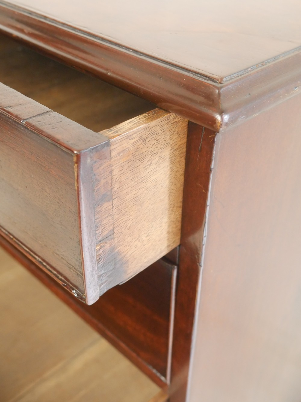 A Georgian mahogany chest of drawers featuring a two-over-three drawer layout, brass swan-neck handles, and bracket feet. View XII