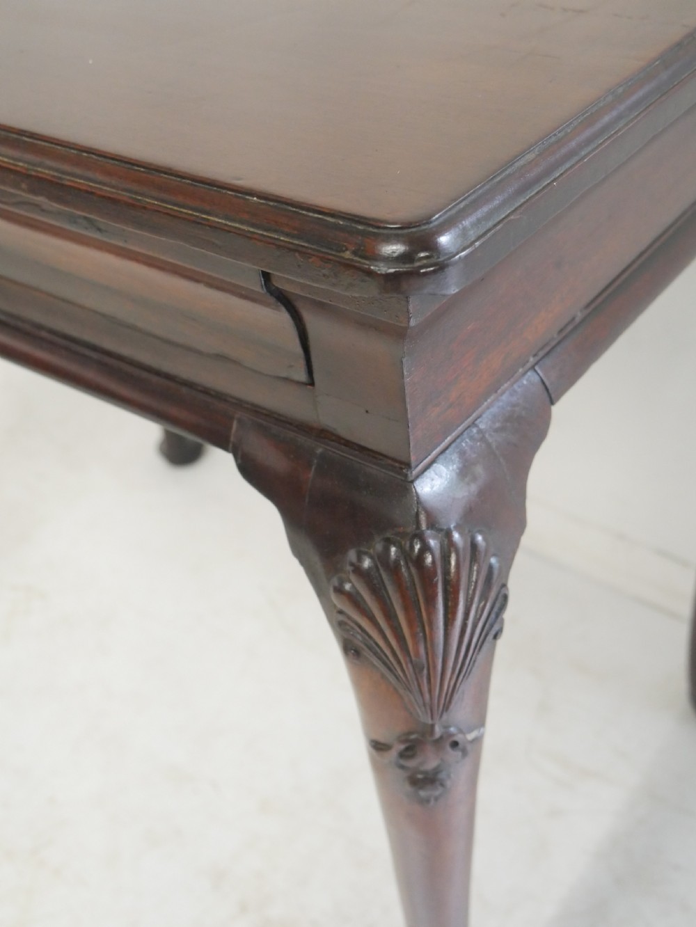 A 19th-century dark mahogany side table featuring a single frieze drawer, carved shell motifs on cabriole legs, and pad feet. View II