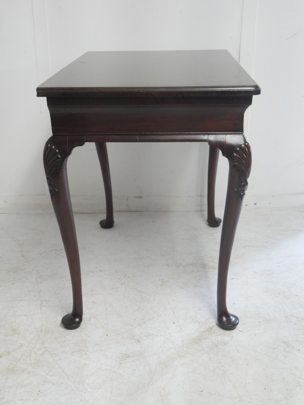 A 19th-century dark mahogany side table featuring a single frieze drawer, carved shell motifs on cabriole legs, and pad feet. View IX