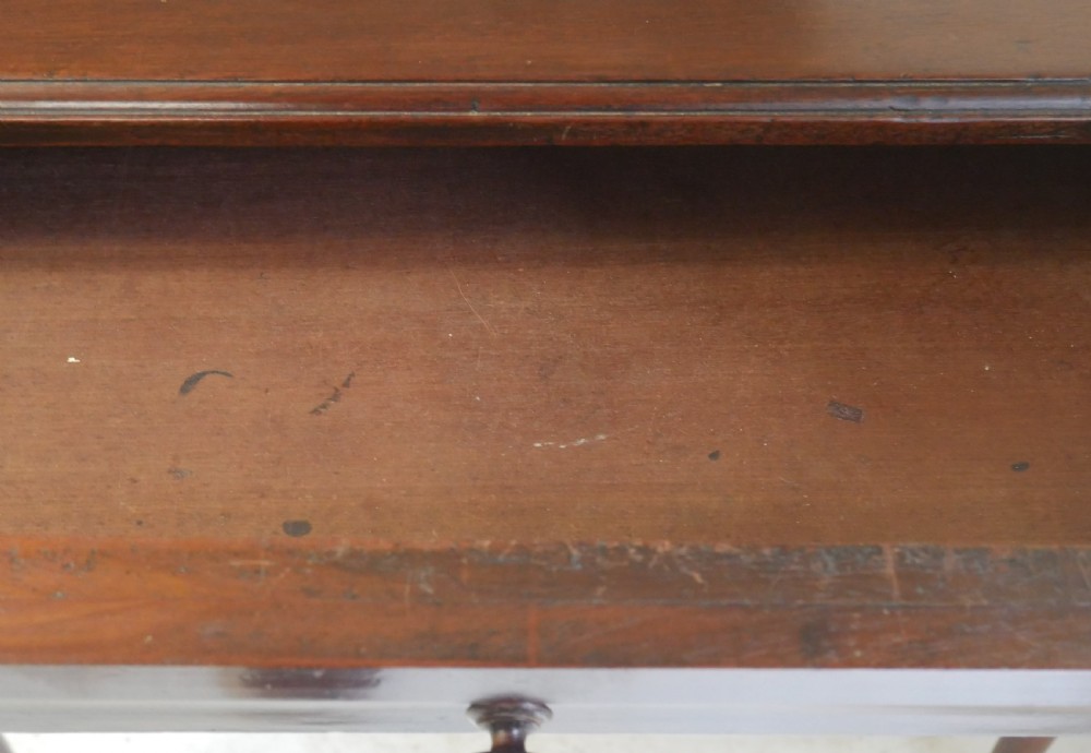 A 19th-century dark mahogany side table featuring a single frieze drawer, carved shell motifs on cabriole legs, and pad feet. View X