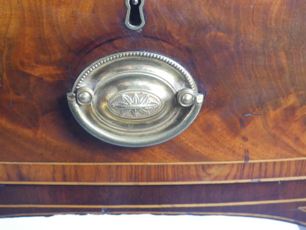 A Georgian bow-front mahogany sideboard featuring satinwood inlays, brass oval handles, and square tapered legs. View VIII